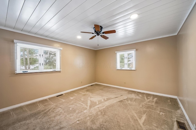 carpeted empty room featuring crown molding, ceiling fan, and wooden ceiling