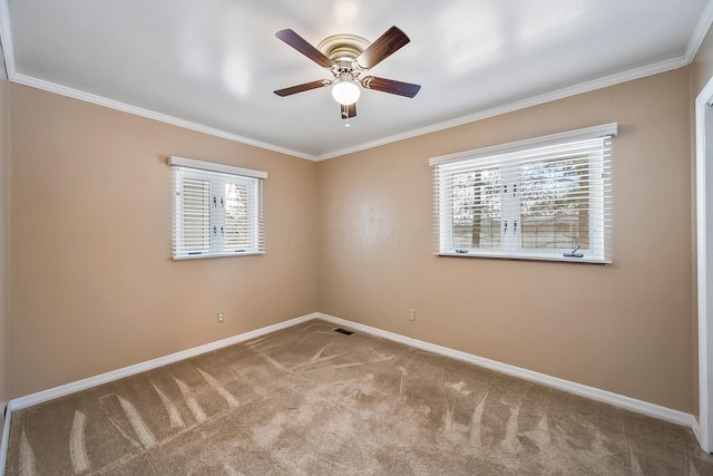 empty room with crown molding, light colored carpet, and ceiling fan