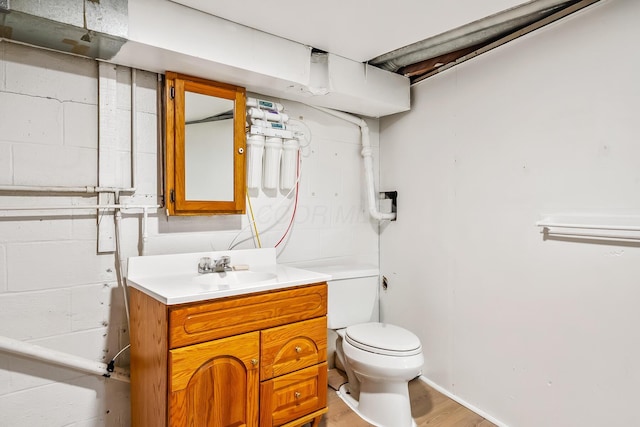 bathroom featuring vanity, toilet, and hardwood / wood-style floors