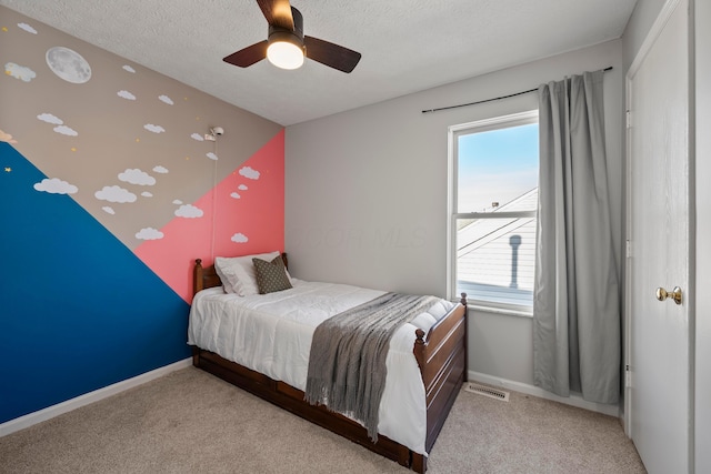 bedroom with vaulted ceiling, light colored carpet, a textured ceiling, and ceiling fan