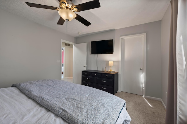 bedroom with light carpet and ceiling fan