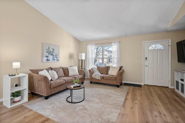 living room featuring vaulted ceiling and light hardwood / wood-style floors