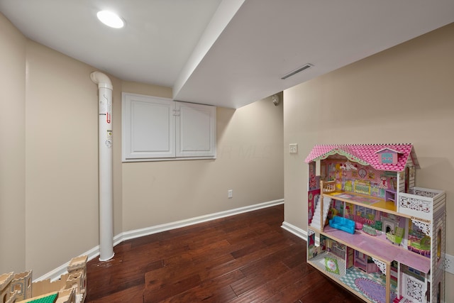 recreation room with dark hardwood / wood-style floors