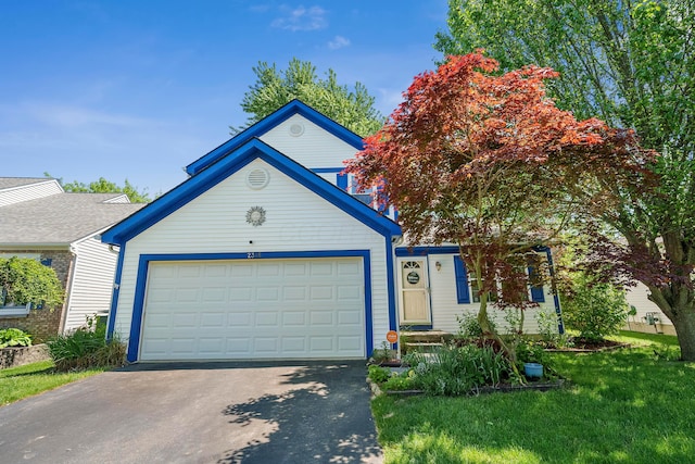 view of front of property featuring a garage and a front lawn