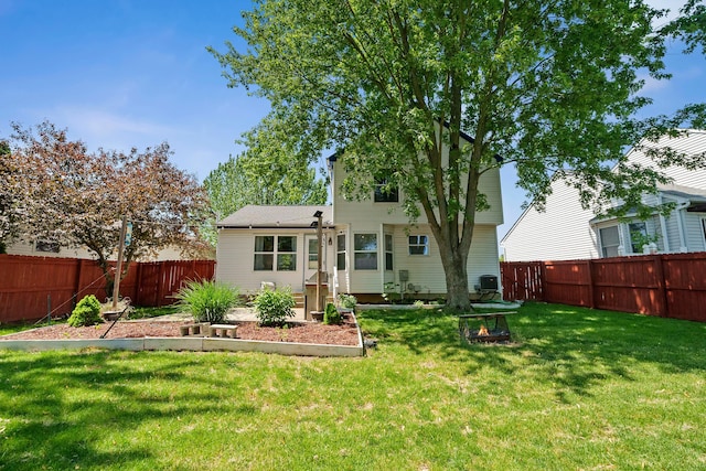 rear view of property with central AC unit and a lawn