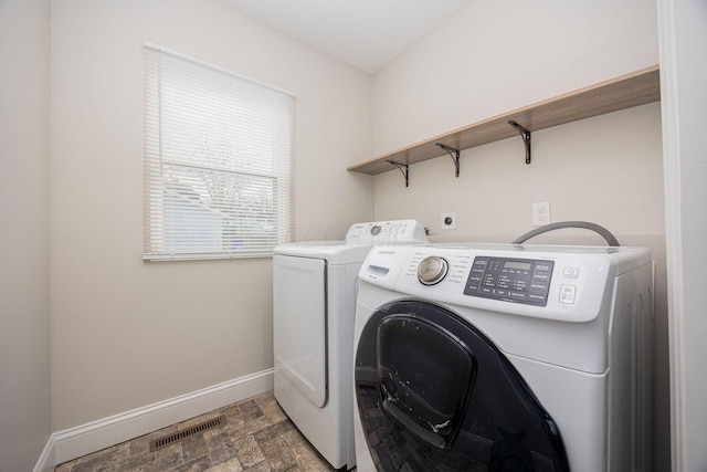 clothes washing area featuring washing machine and clothes dryer