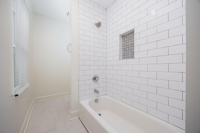 bathroom with tiled shower / bath combo and tile patterned floors