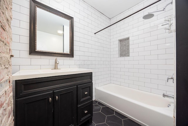 bathroom with tiled shower / bath, vanity, and tile patterned flooring