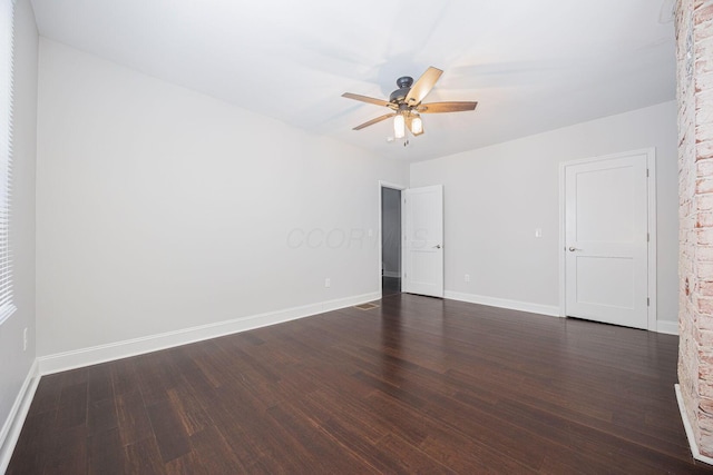 empty room featuring ceiling fan and dark hardwood / wood-style floors