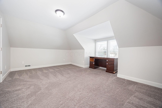 bonus room featuring light carpet and lofted ceiling