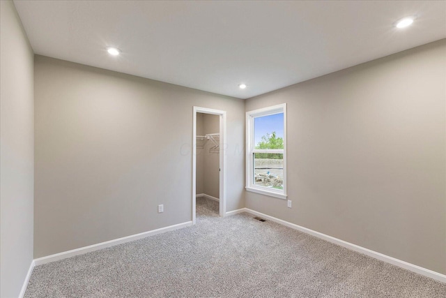 1221 Heathgate Way, Fairborn, OH 45324 - unfurnished bedroom featuring carpet floors, baseboards, a walk in closet, recessed lighting, and a closet