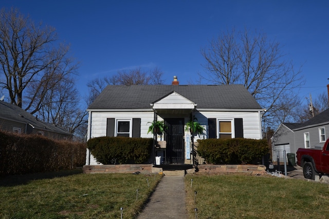 bungalow-style home featuring a front lawn