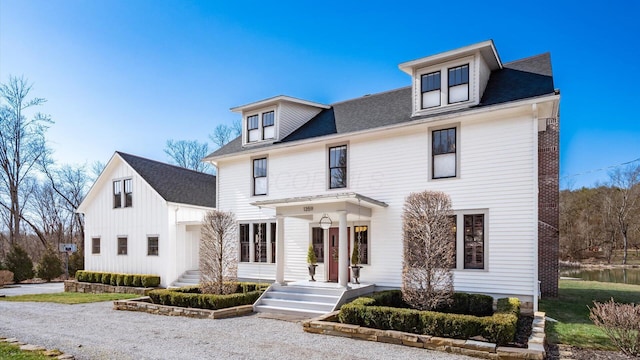 view of front of home featuring roof with shingles and board and batten siding