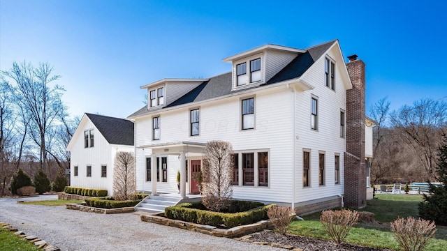 view of front of home featuring a chimney