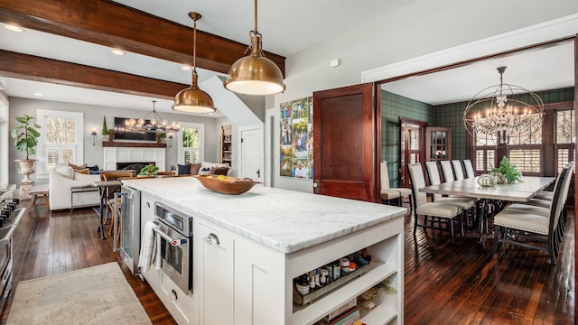 kitchen featuring a notable chandelier, dark wood-style flooring, a center island, and stainless steel oven