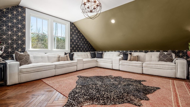 living room featuring an inviting chandelier and lofted ceiling