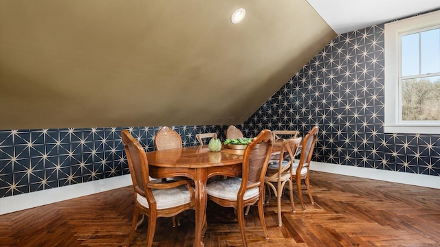 dining area with baseboards and lofted ceiling