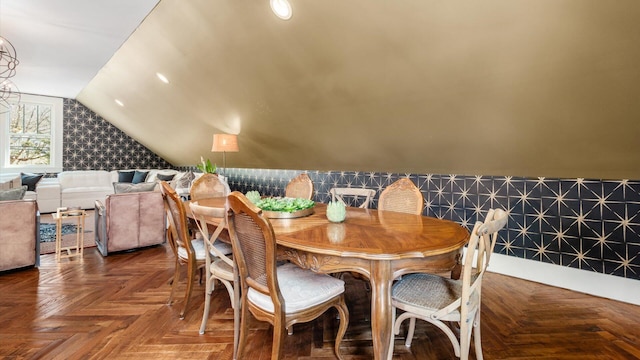 dining space featuring vaulted ceiling