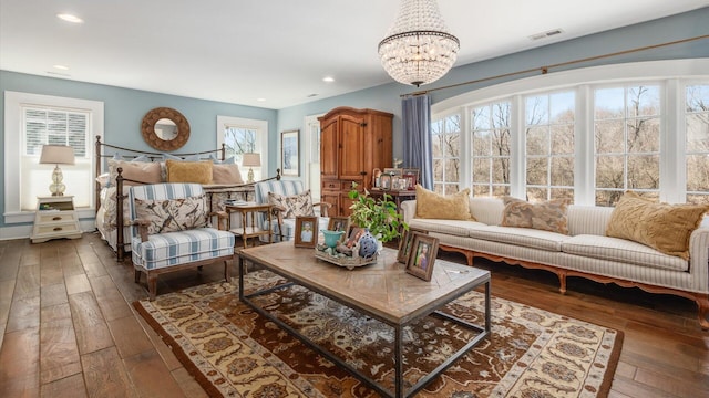 interior space with hardwood / wood-style floors, recessed lighting, visible vents, and a chandelier