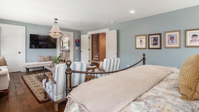 bedroom with a notable chandelier, recessed lighting, and dark wood-style flooring