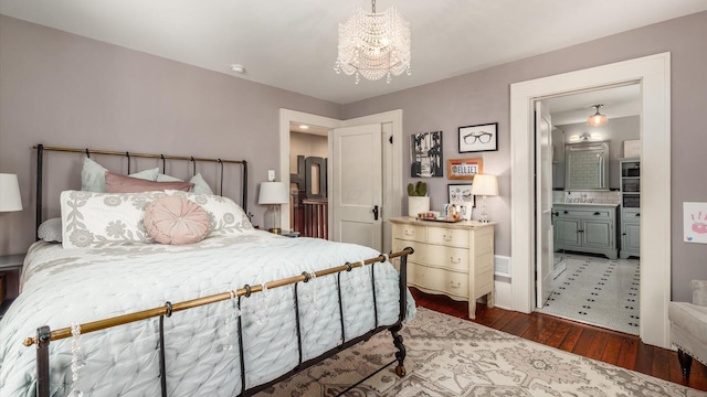 bedroom featuring hardwood / wood-style flooring, a notable chandelier, and ensuite bathroom