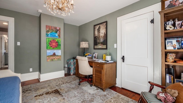 office space featuring a notable chandelier and wood finished floors