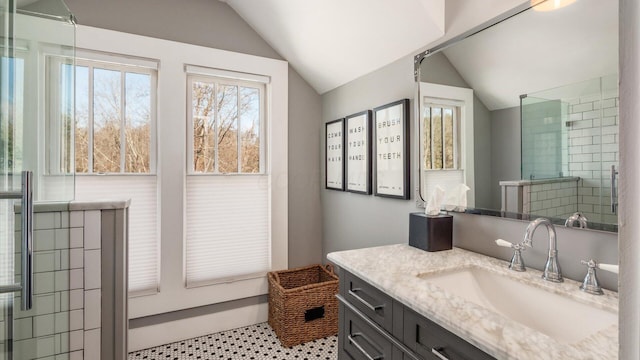 bathroom featuring lofted ceiling and vanity