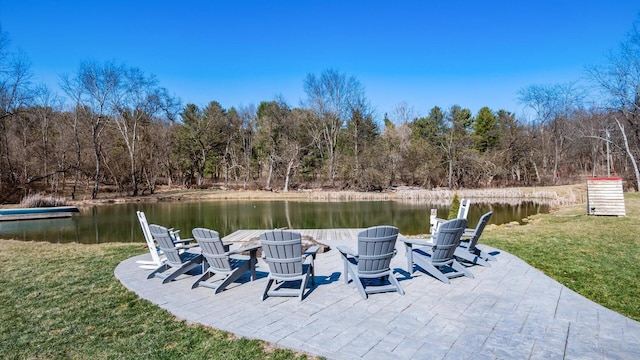 view of patio / terrace with a water view and a wooded view