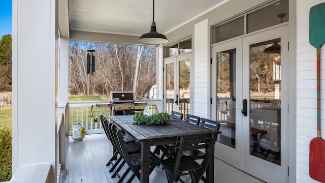 sunroom featuring a healthy amount of sunlight and french doors