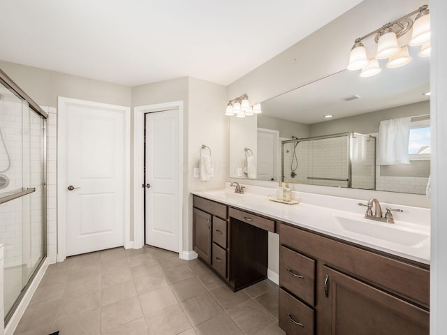 bathroom featuring an enclosed shower, vanity, and tile patterned flooring