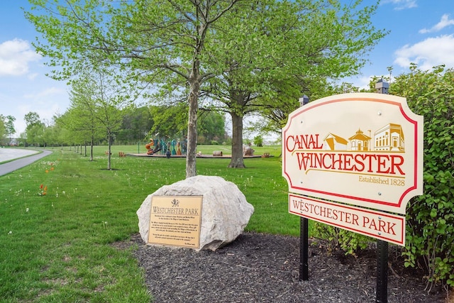 view of property's community featuring a playground and a lawn