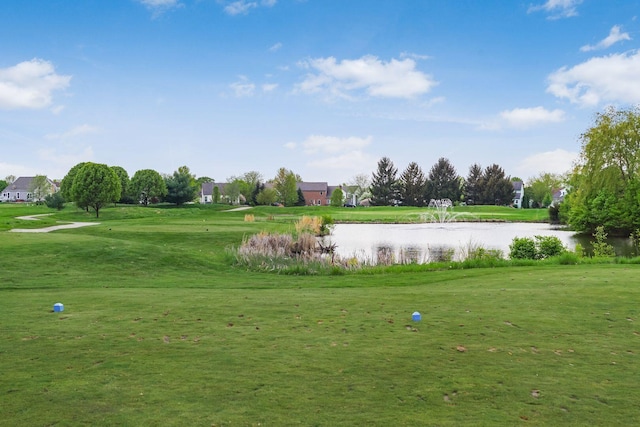 surrounding community with a lawn and a water view