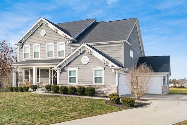 view of front of house with a garage, a porch, and a front yard