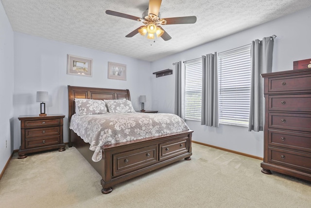 carpeted bedroom with a textured ceiling and ceiling fan