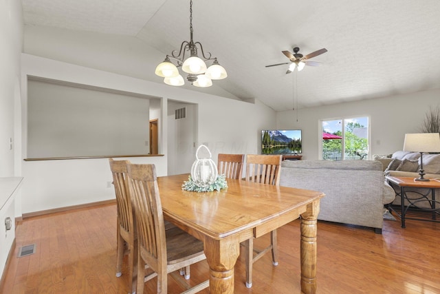 dining area with light hardwood / wood-style flooring, ceiling fan with notable chandelier, and vaulted ceiling