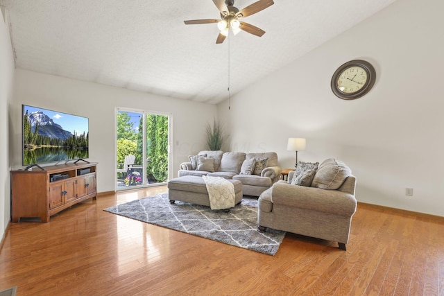 living room featuring wood-type flooring, vaulted ceiling, and ceiling fan