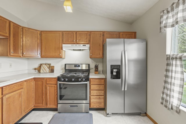 kitchen featuring lofted ceiling and appliances with stainless steel finishes