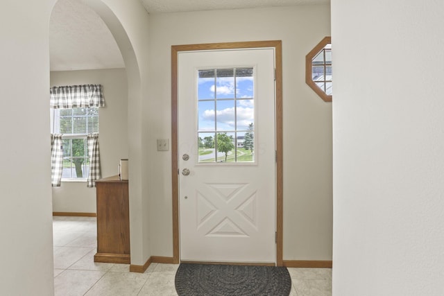 entryway with light tile patterned floors