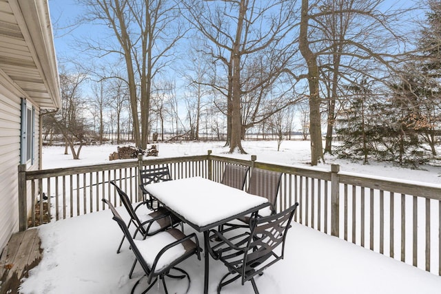 snow covered deck with outdoor dining area