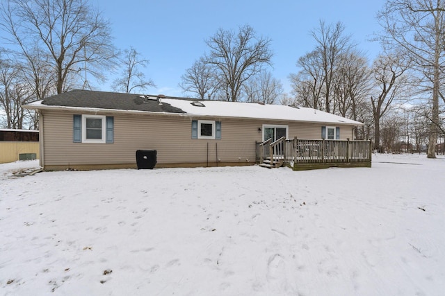 snow covered property with a deck