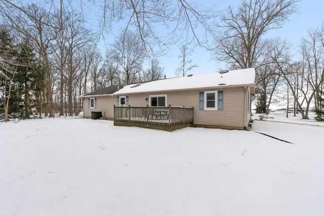 snow covered property featuring a wooden deck