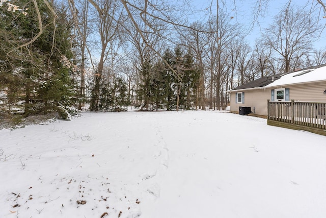 yard covered in snow featuring a wooden deck