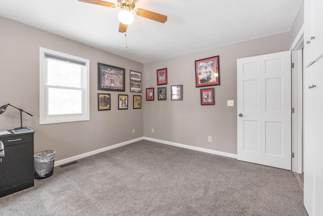 bedroom with light colored carpet, ceiling fan, visible vents, and baseboards