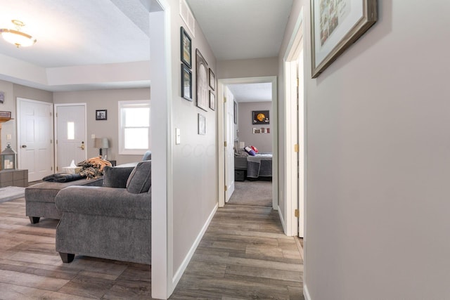 hall with wood finished floors and baseboards