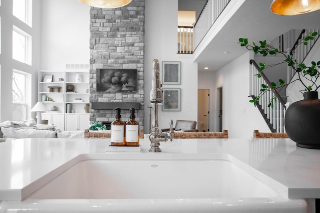 kitchen featuring a towering ceiling and a healthy amount of sunlight