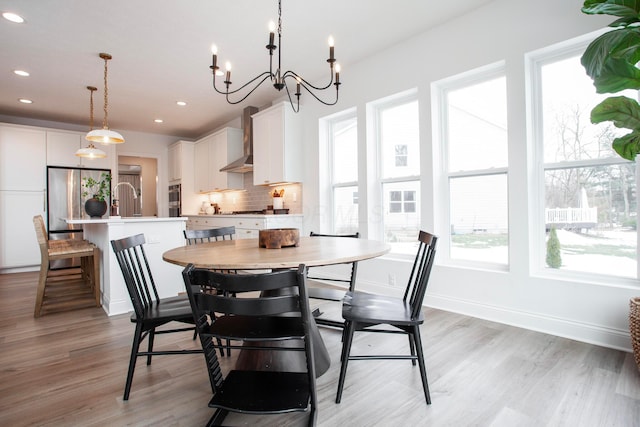 dining area with sink and light wood-type flooring