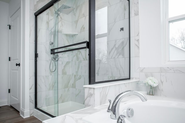 bathroom featuring independent shower and bath and hardwood / wood-style floors