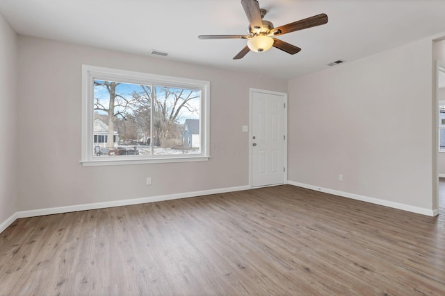 empty room featuring ceiling fan and light hardwood / wood-style flooring