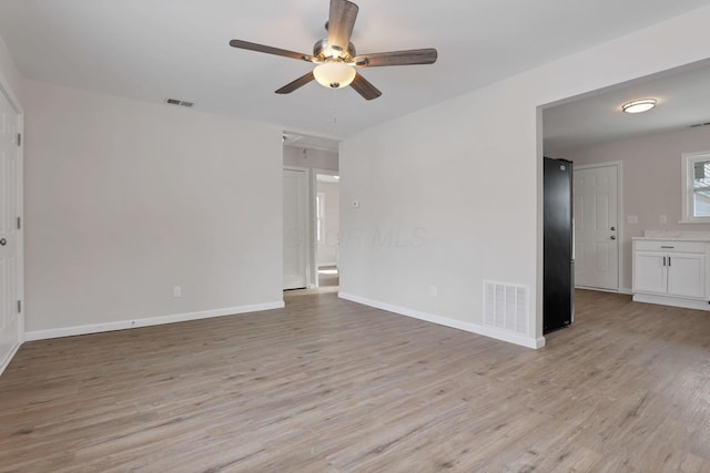 empty room featuring ceiling fan and light wood-type flooring