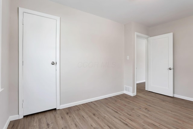 spare room featuring light hardwood / wood-style flooring